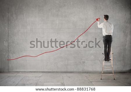 Businessman creating a chart of the earnings Businessman creating a chart of the earnings