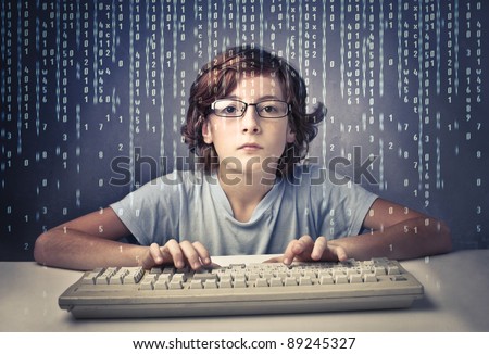 Child using a computer with binary code on the screen