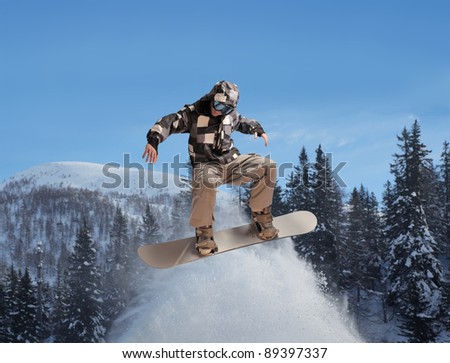 Young man snowboarding in the mountains
