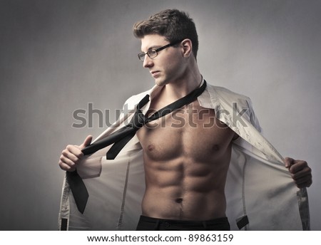 Young businessman putting off his skirt and tie