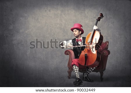 Young elegant man playing the cello