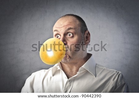 Man blowing bubbles with a chewing gum