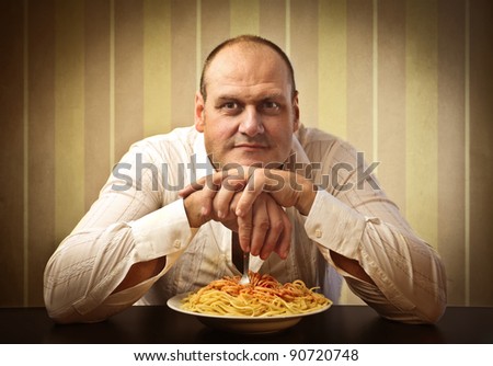 Fat man in front of a plate of spaghetti