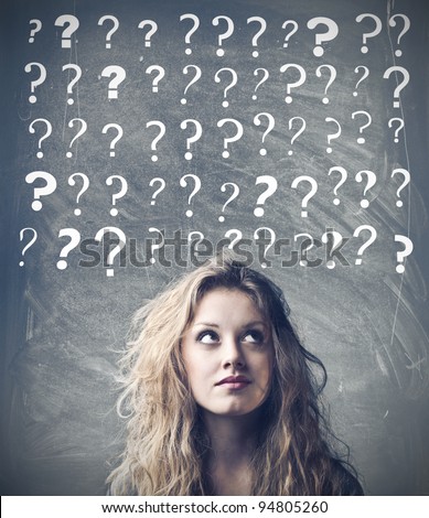 stock photo : Beautiful woman with questioning expression and question marks above her head