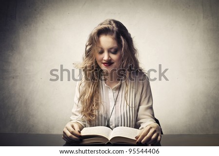 Smiling beautiful woman reading a book