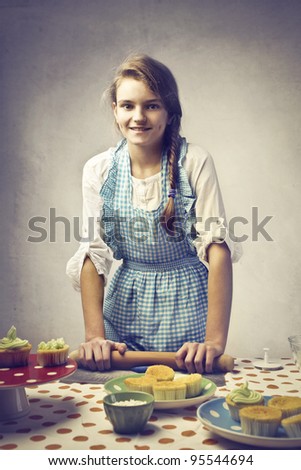 Smiling teenage girl baking sweets