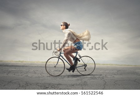 beautiful woman pedaling a bicycle