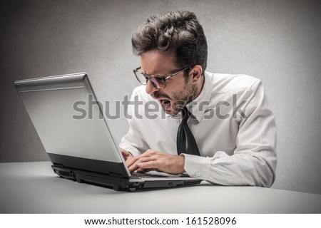 Angry Businessman Working On The Computer