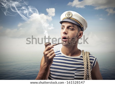 young captain smokes a pipe