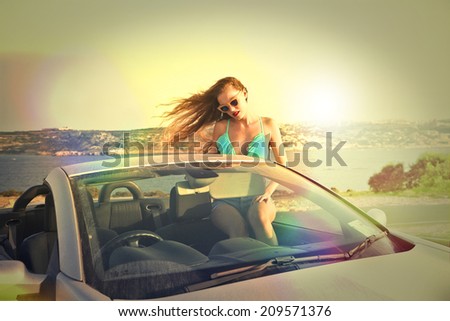 beautiful woman in a cabriolet