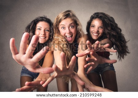 three young women that are having fun together