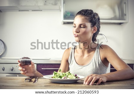 young girl deciding whether to eat healthy food or a sweet