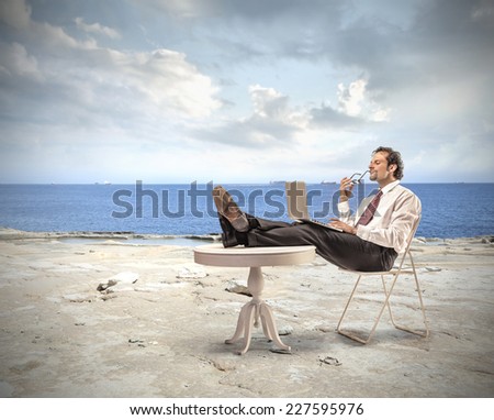 Businessman working at the seaside