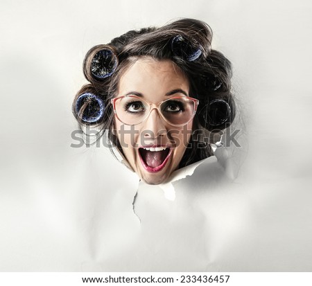 Happy crazy woman popping out from a cardboard