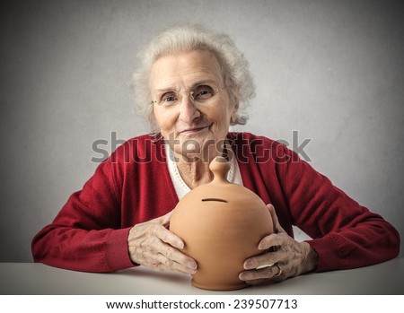 A grandma holding a piggy bank
