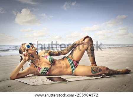 Tattooed girl at the beach