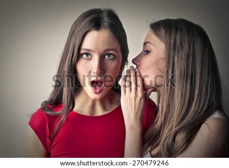 Sisters whispering secrets