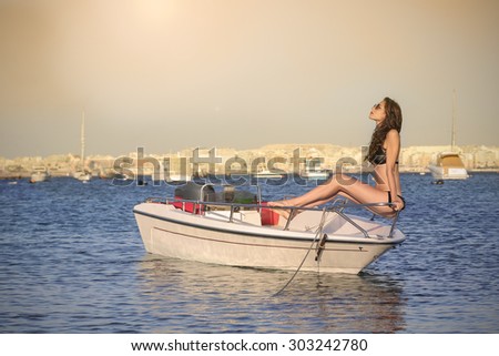 Girl sunbathing on a little boat