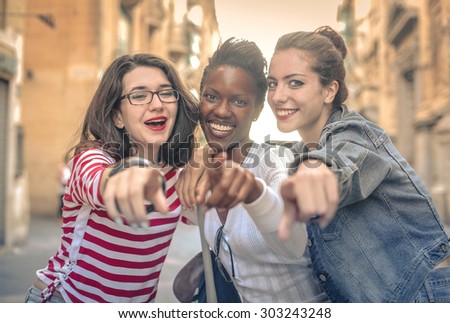 Three friends pointing at something