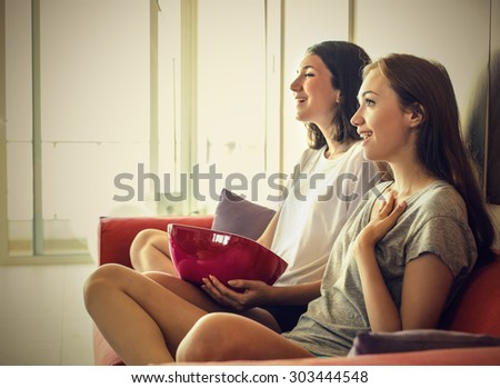 Girls sitting on the sofa enjoying a movie