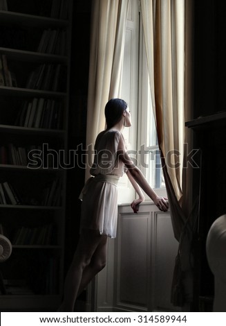 Woman staring out of a window