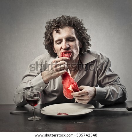 Disgusting man eating raw meat