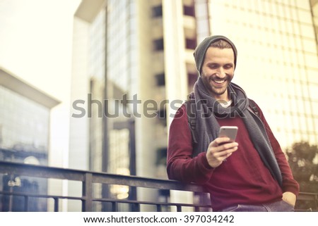 Happy man checking his phone