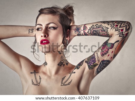 Beautiful tattooed woman with red lipstick