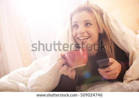 Girl watching Tv in bed