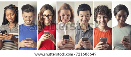 Smiling people using smart phones