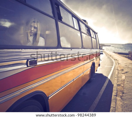 Young woman sitting in a coach bus [design of the bus modified]