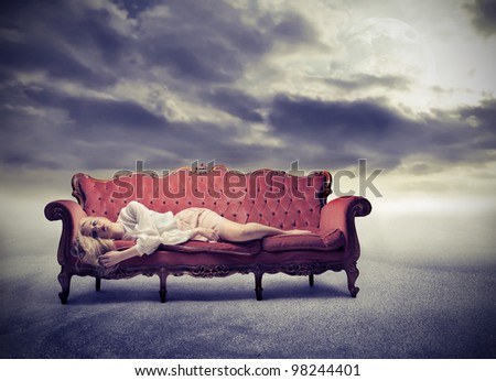 Sad woman lying on a sofa