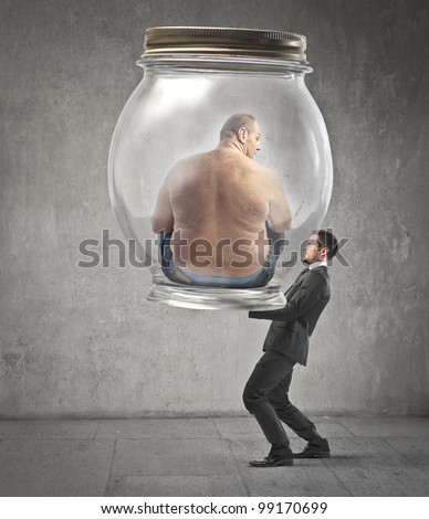 Businessman carrying a jar with an obese man in it