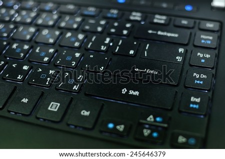 Macro Black Enter Key Pad on Keyboard of Laptop with LED inside. focus on only Enter Key.