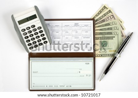 An open checkbook showing the calendar with a pen to the right side. Has a calculator and cash with it.