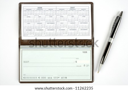 An open checkbook showing the calendar with a pen to the right side.
