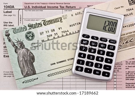 US government stimulus refund check with calculator and tax form 1040a. Numbers have been altered and name removed.