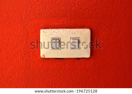 light switch on a orange wall