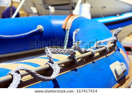 Blue inflatable boat at marina