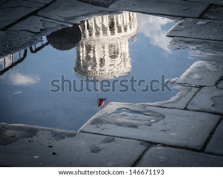 Detail of the Tower of Pisa reflected in a pool, Pisa, Tuscany, italy