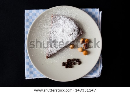 slice of chocolate cake with hazelnut and coffee, powdered sugar