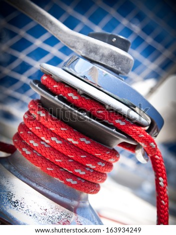 Winch of a sailboat, detail of a red rope during a sailing