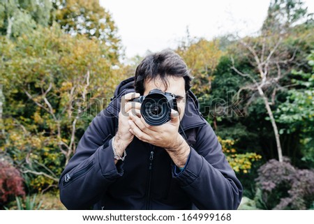 Professional photographer in a London park during a photo shoot in outdoor