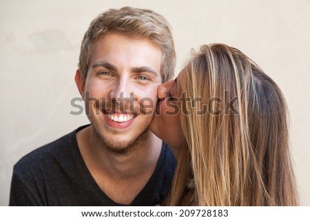 Girl kissing her boyfriend on the cheek