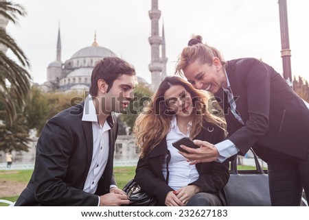 Three young business team Working in front of Blue Mosque in Istanbul