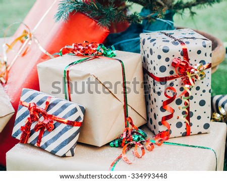Christmas Day. Christmas gift packages with ribbons of various colors under the Christmas tree
