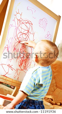 The child draws on the board 2