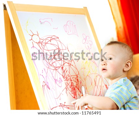 The child draws on the board