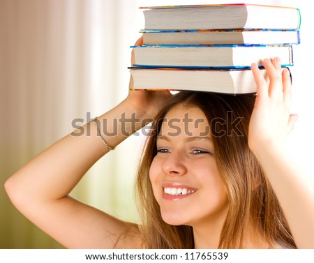 Beautiful young female student carrying books 4