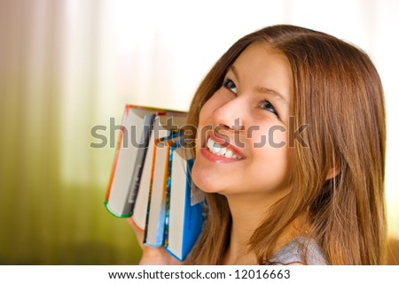Beautiful young female student carrying books